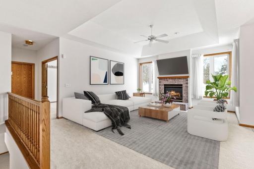 Open living room with generous space and gas fireplace. (photo is virtually staged)