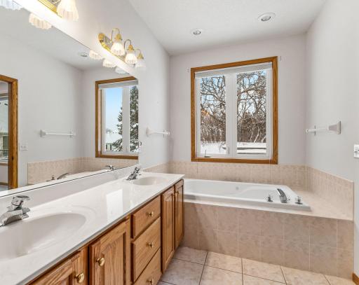 En suite bathroom has both a bathtub and walk-in shower