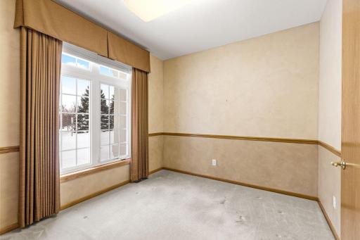 Main floor den or office with a view of the front yard