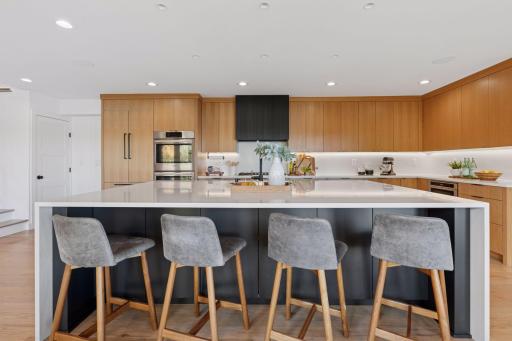 Warm oak cabinetry pairs beautifully with clean modern lines and quartz counters.