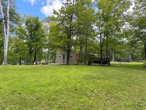 At the end of a dead-end road, here is a gorgeous 6 acre lot for your potential future dream home or cabin plans! Views of the meadow and the bunkhouse with the lakeshore beyond.