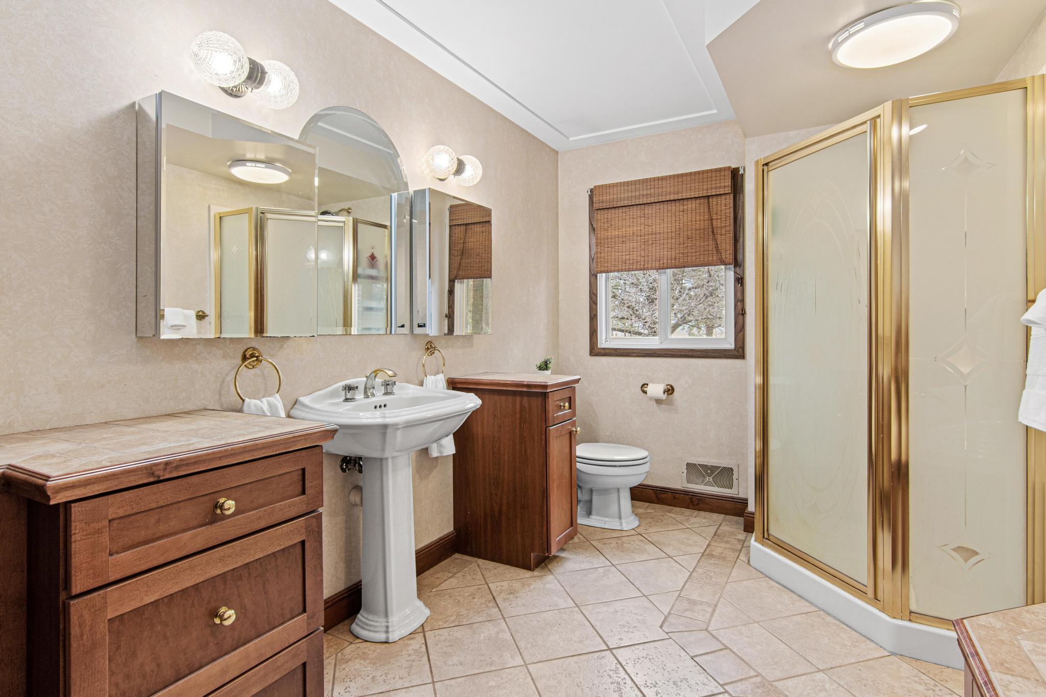 Main level full bath with heated floors and separate tub and walk-in shower.
