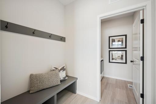 Spacious mudroom with built-in bench and separate Laundry room