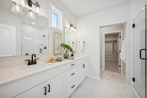 Primary bathroom with lovely double sinks and storage, Large tiled shower and heavy glass shower door! And you will LOVE the huge walk-in closet!