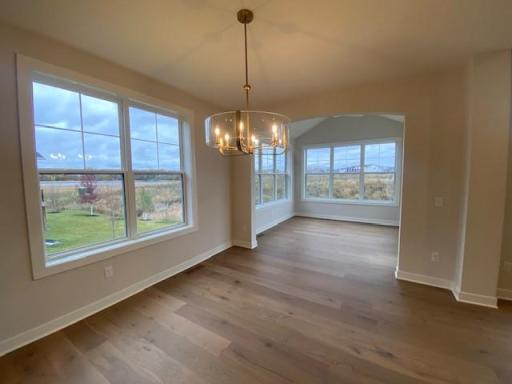 Charming Villa with 10' ceiling at gathering room, dining area leads to 4-season porch and low-maintenance deck w/stairs.