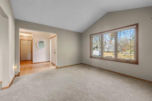 View of the foyer from the formal livingroom. Notice all the lovely windows throughout the home for a bright and inviting ambience.