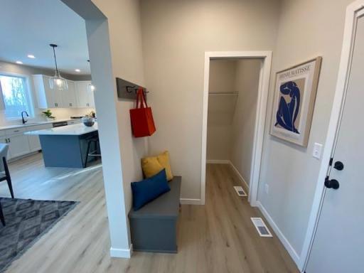 Mudroom with builtin bench, large walkin closet and powder room!