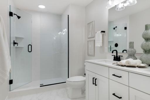 Primary Private Bathroom with large tiled shower and dual sinks, and walk-in closet!
