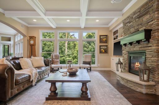 The wall of windows from the main level living room offers breathtaking westerly views over the backyard. Put on the fireplace and relax this fall!