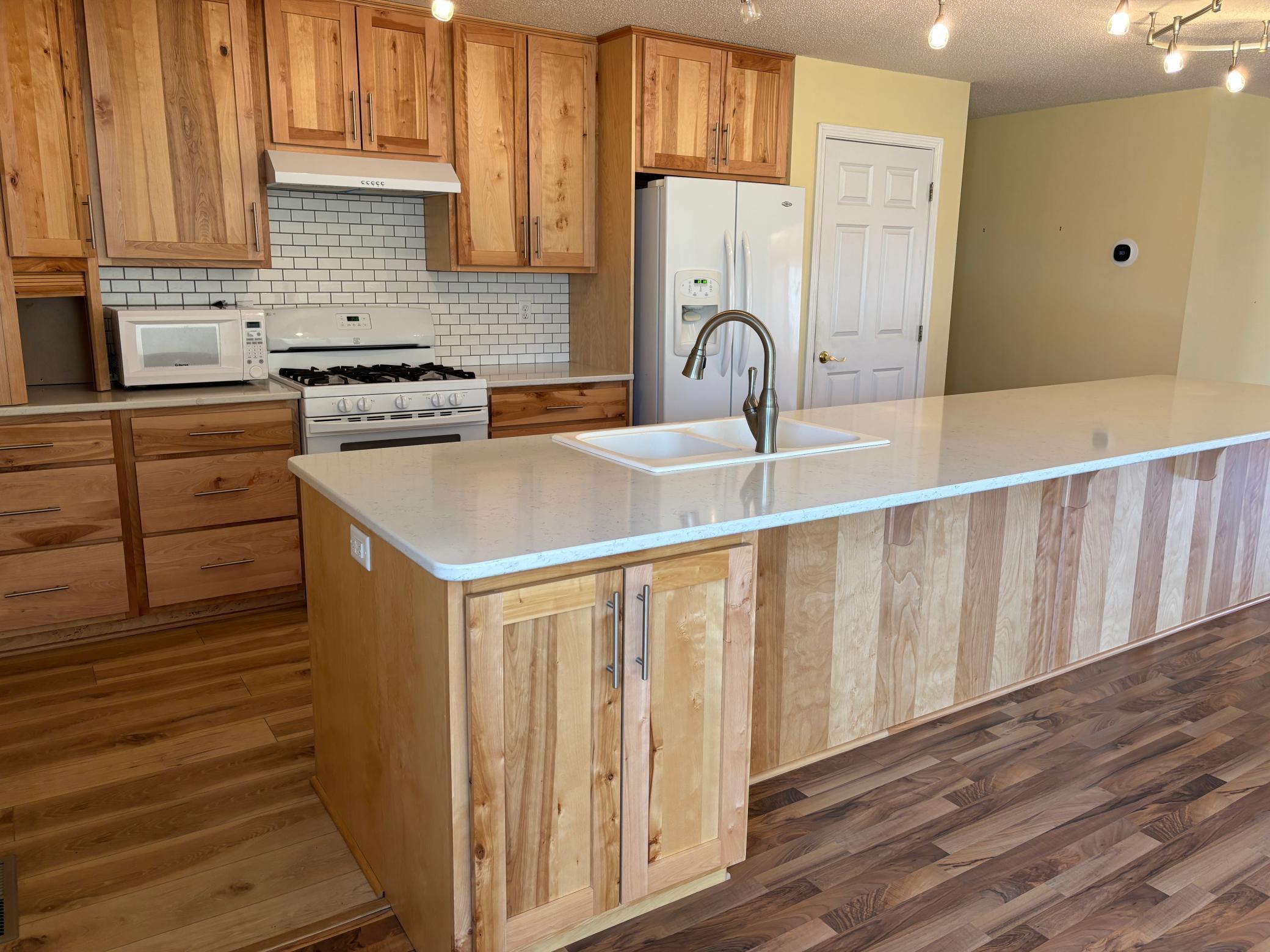 A very nice kitchen for you to enjoy. Grab a stool and eat at the large kitchen island.
