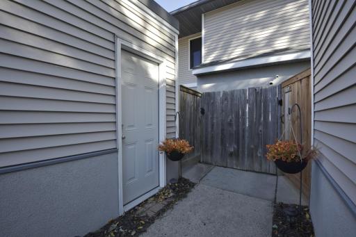 Photo for 1124 Trailwood S, Hopkins, MN 55343 - listing #6808573 Walking up the sidewalk from the parking lot- another service door to the garage, gate entrance to the unit is the one on the left.