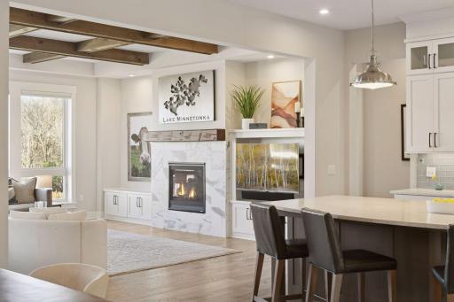 The inviting living room centers around the gas fireplace, while large windows fill the space with natural light.