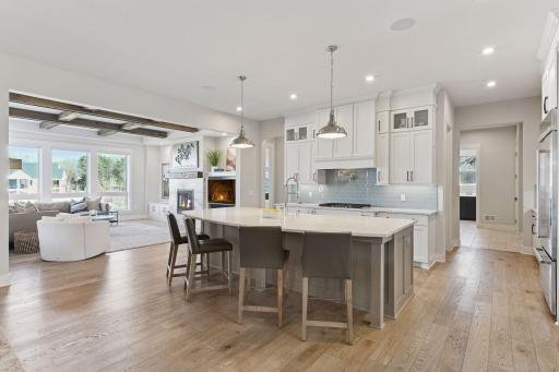 The open-concept main level is as functional as it is beautiful, showcasing custom cabinetry, hardwood floors, designer lighting, and 10-foot ceilings throughout.