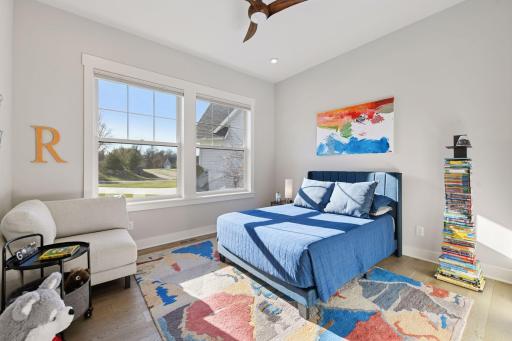 The main level also includes two additional bedrooms, a laundry room, and hallway study area.