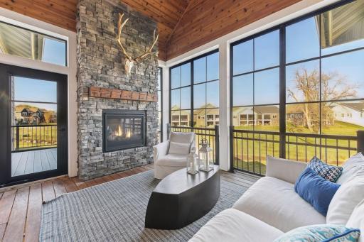 Enjoy gathering around the fire in the screened-in porch overlooking the spacious backyard.
