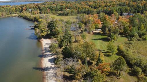 Look at this gorgeous stretch of beach in front of a nice level area of lawn. You can see the gently shallow entrance to the lake as well with a hard sand bottom!
