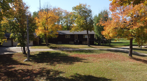 The existing home with a three car garage to the left. While it is likely a tear-down, the existing owner's family has enjoyed using it for decades!