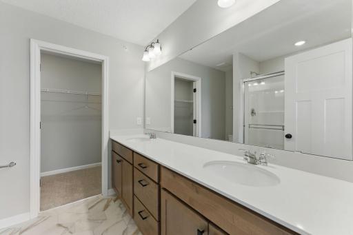 Owners private bath with double vanity and walk-in shower