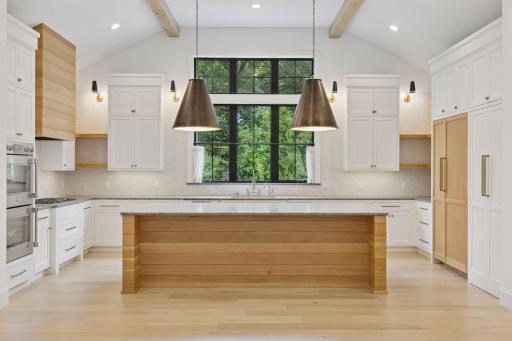 Incredible kitchen for everyday living or large scale entertaining. Double swing ovens, custom inset kitchen cabinets, luxury appliances. The white door on the right is an access to the butler pantry.