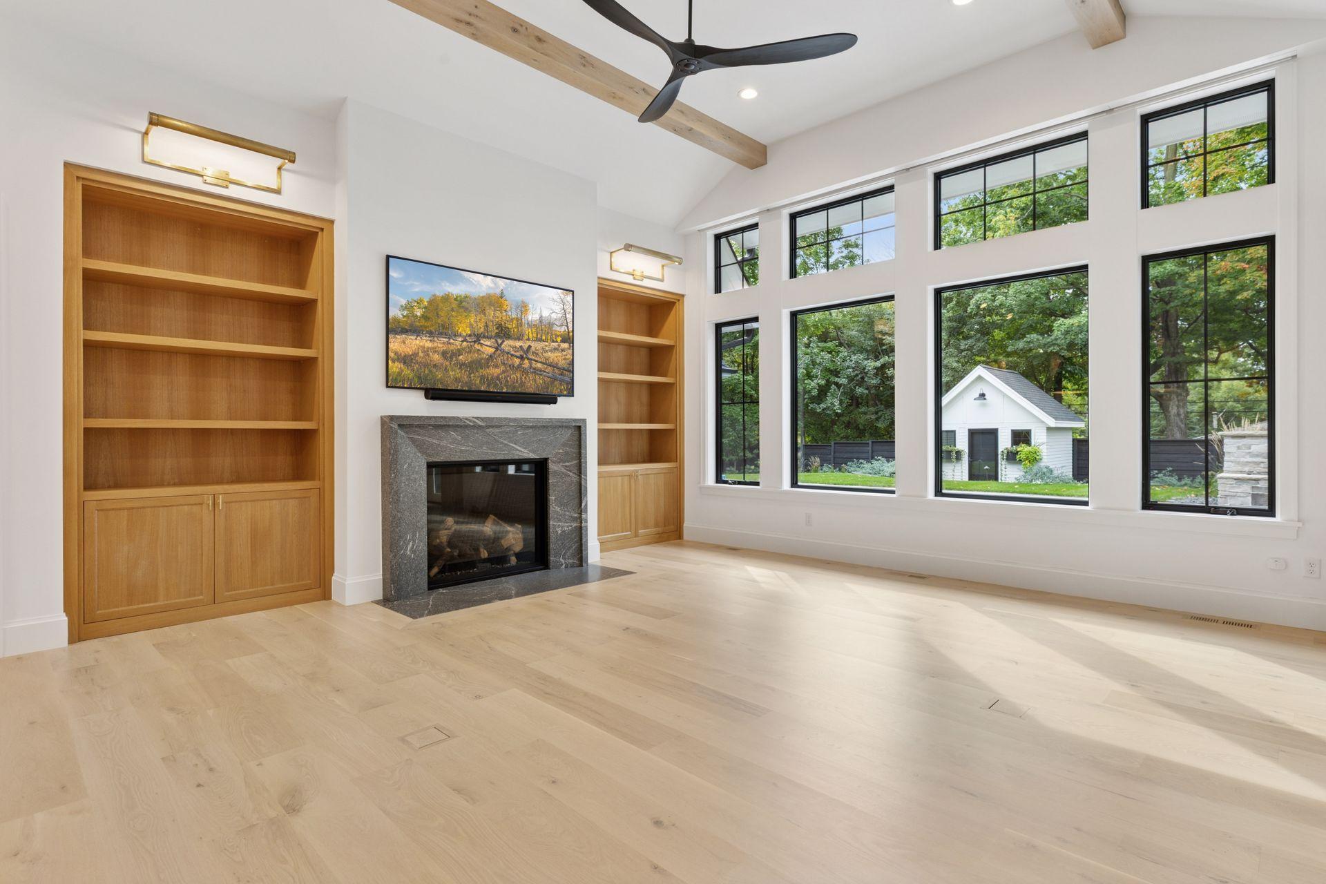 Main floor family room, vaulted ceilings, gas fire place, plenty of natural light and custom built-ins. See cute matching shed in background.
