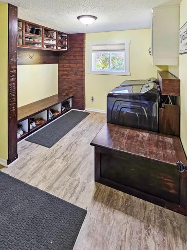 The mud/laundry room is right off the garage and offers lots of storage with the custom bench and shelves. it is also plumbed for a sink if you choose.