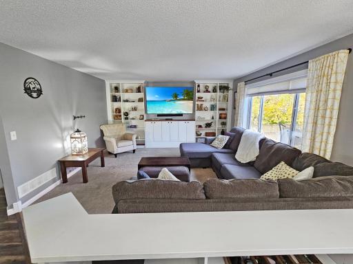 The large living room offers lots of natural light and tons of storage thanks to the custom built-ins.