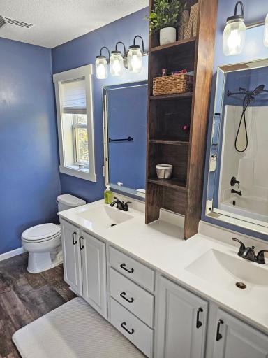 Primary bedroom's full bath offers dual sinks.