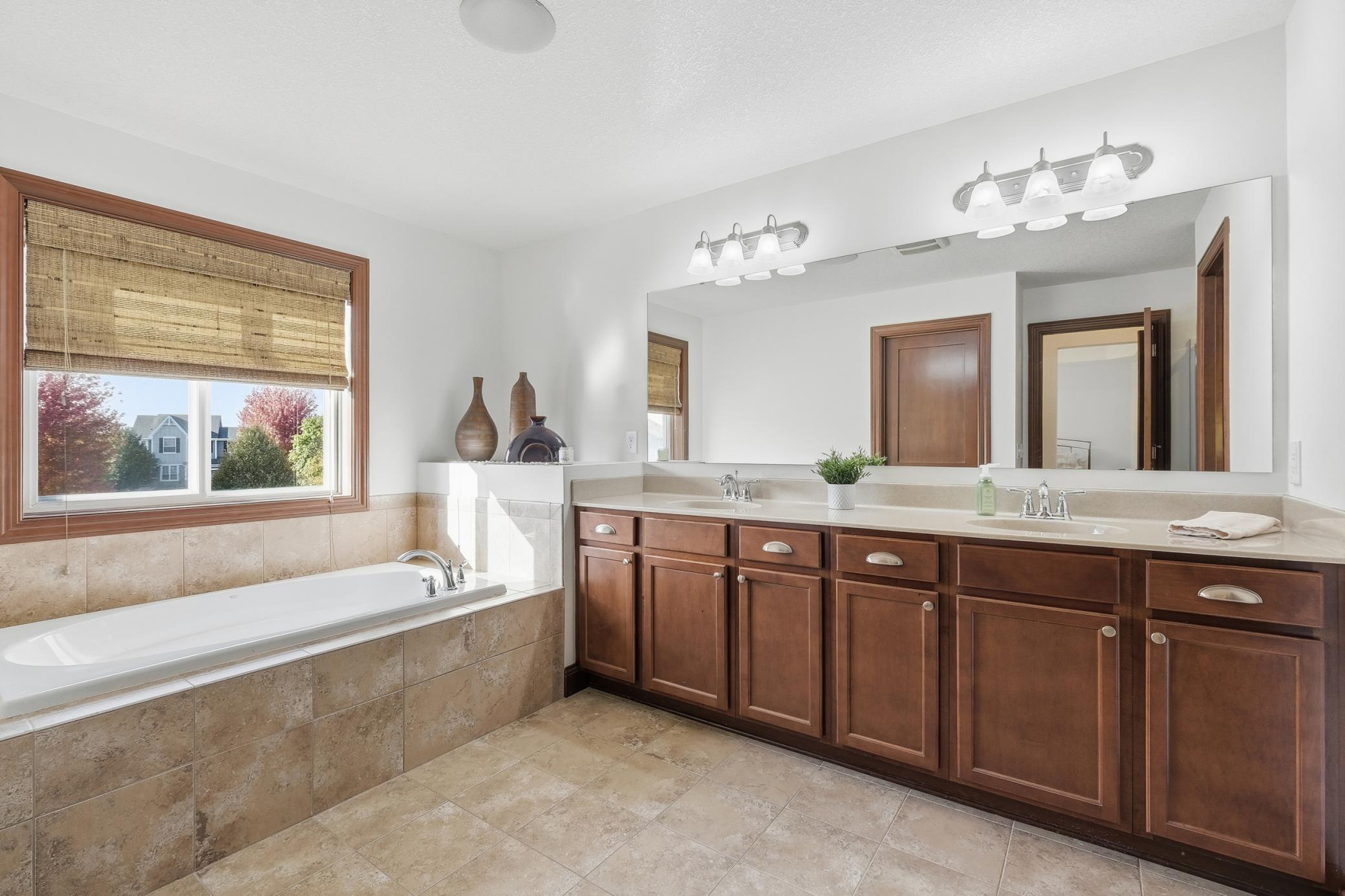 Private owners suite oasis with double vanities, garden tub and separate water closet and a glassed in shower.