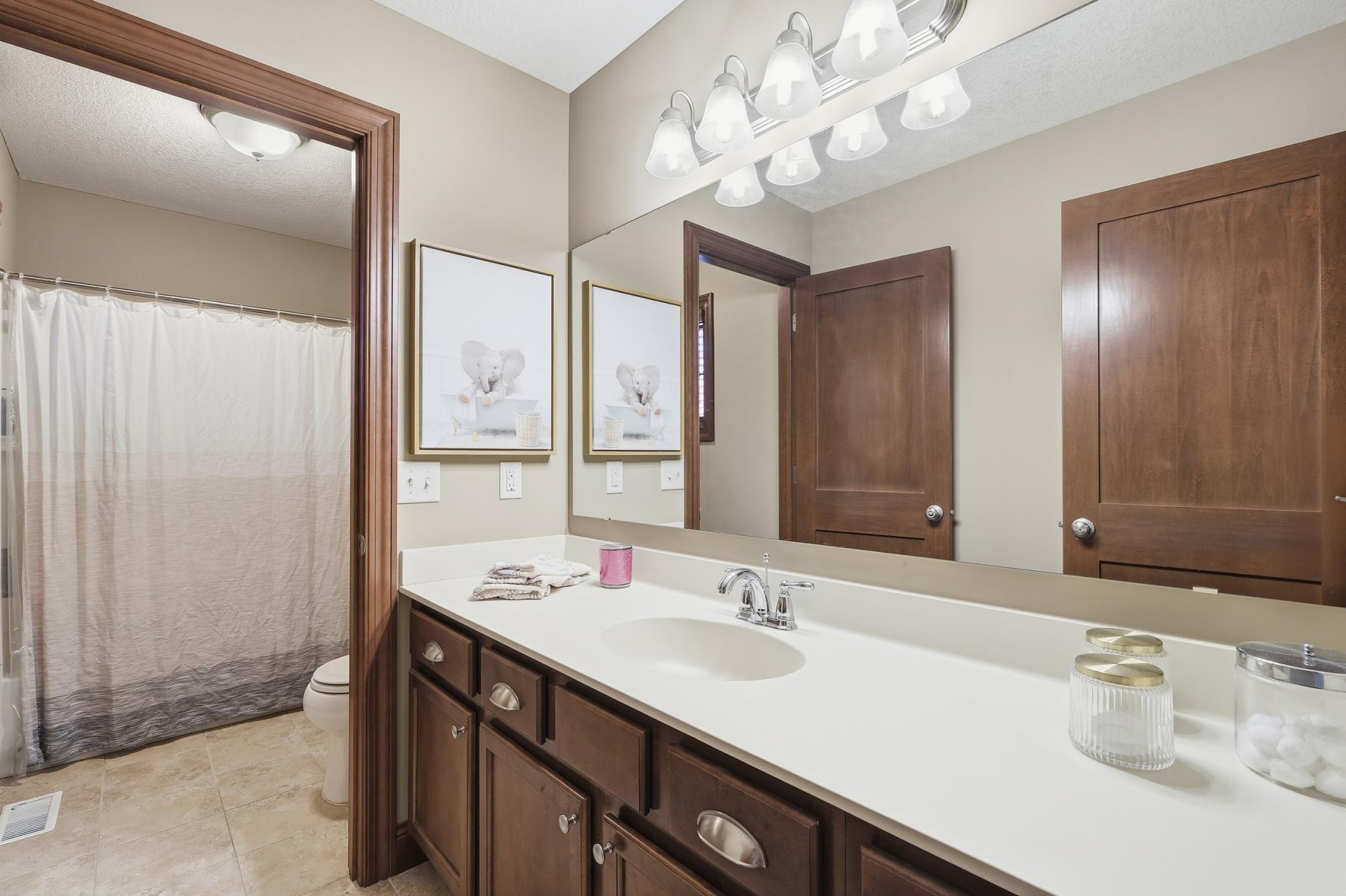 Upper level bathroom with a large vanity.
