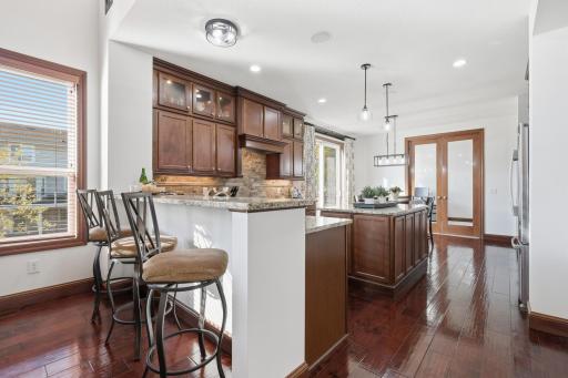 The gourmet kitchen is a chefs delight with its plenty of prep space and is ideal for entertaining. Upgrades include under cabinet lighting, full cabinets with glass, backspash, hood, stove and double ovens.