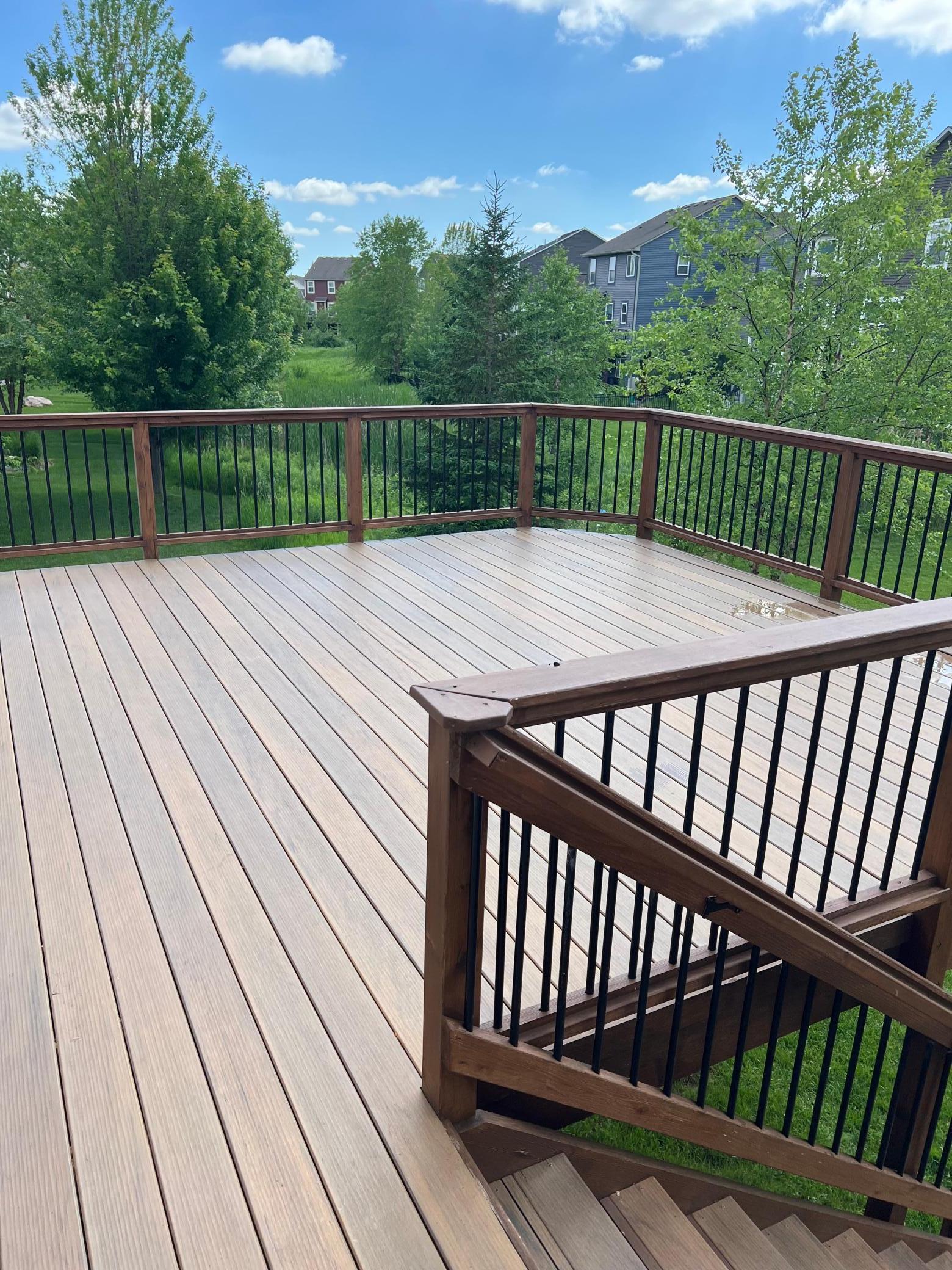 Spacious upgraded deck with stairs to grade.