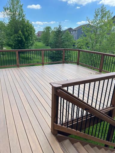 Spacious upgraded deck with stairs to grade.