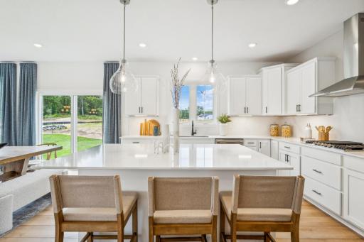 (Photo of model home, finishes will vary) The focal point of this modern kitchen is an inviting center island that provides additional counter and seating space. It is surrounded by ample cabinetry and all-new stainless steel appliances.