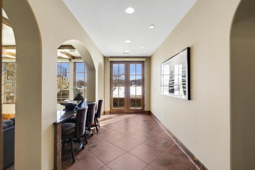 The walkout lower level is set for entertaining lake guests, boasting a fully equipped bar attached to the media room, a climate-controlled wine room, a tasting room, a 5th bedroom, additional storage, and a lake storage room with a 2nd laundry.