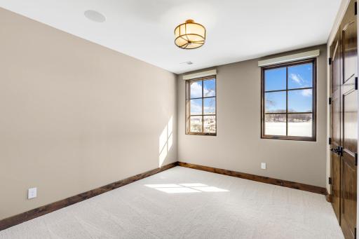 The 5th bedroom, located on the lower level, is designed as a flex space for an office.