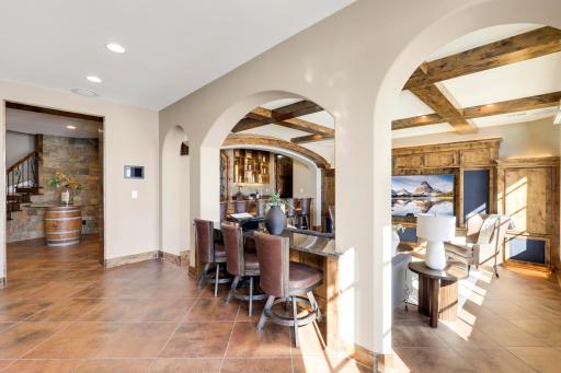The walkout lower level is set for entertaining lake guests, boasting a fully equipped bar attached to the media room, a climate-controlled wine room, a tasting room, a 5th bedroom, additional storage, and a lake storage room with a 2nd laundry.