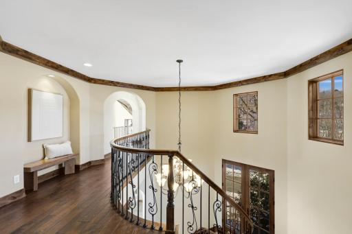 The upper-level hosts the primary ensuite and three additional bedrooms supported by two additional bathrooms, a well-appointed laundry room and a reading nook overlooking the great room.