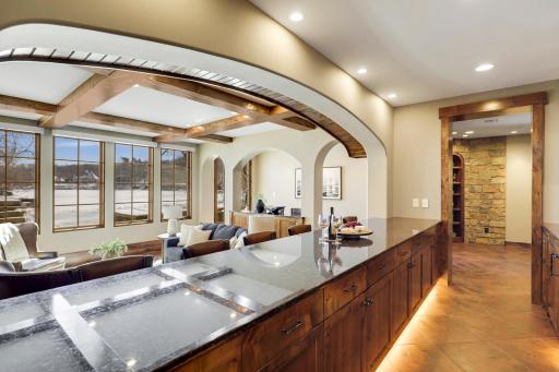 The walkout lower level is set for entertaining lake guests, boasting a fully equipped bar attached to the media room, a climate-controlled wine room, a tasting room, a 5th bedroom, additional storage, and a lake storage room with a 2nd laundry.