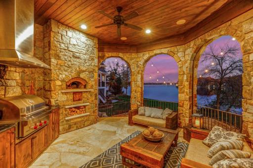 Possibly the most utilized room in the home, the California room, positioned next to the kitchen, offers a wood-fired pizza oven, a built-in gas grill, an outdoor TV, and motorized Phantom screens.