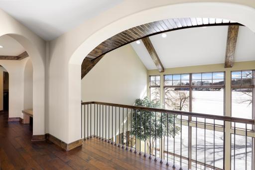 The upper-level hosts the primary ensuite and three additional bedrooms supported by two additional bathrooms, a well-appointed laundry room and a reading nook overlooking the great room.