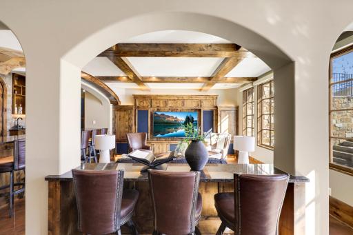 The walkout lower level is set for entertaining lake guests, boasting a fully equipped bar attached to the media room, a climate-controlled wine room, a tasting room, a 5th bedroom, additional storage, and a lake storage room with a 2nd laundry.