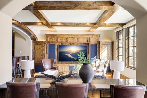 The walkout lower level is set for entertaining lake guests, boasting a fully equipped bar attached to the media room, a climate-controlled wine room, a tasting room, a 5th bedroom, additional storage, and a lake storage room with a 2nd laundry.