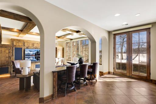 The walkout lower level is set for entertaining lake guests, boasting a fully equipped bar attached to the media room, a climate-controlled wine room, a tasting room, a 5th bedroom, additional storage, and a lake storage room with a 2nd laundry.