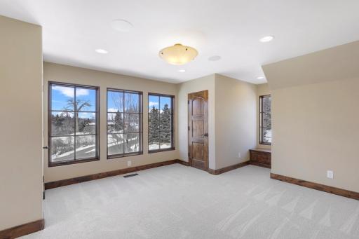The upper-level hosts three additional bedrooms supported by two additional bathrooms, a well-appointed laundry room and a reading nook overlooking the great room.