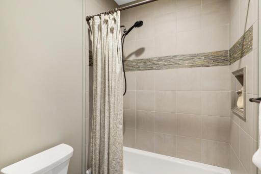 This full bathroom serves the lower-level bedroom and common spaces.