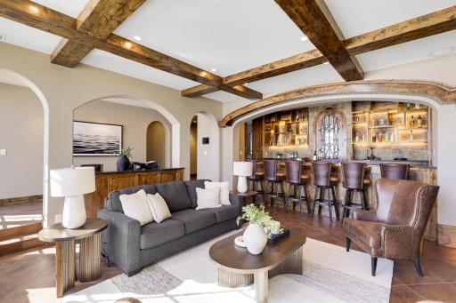 The walkout lower level is set for entertaining lake guests, boasting a fully equipped bar attached to the media room, a climate-controlled wine room, a tasting room, a 5th bedroom, additional storage, and a lake storage room with a 2nd laundry.