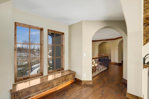 The upper-level hosts the primary ensuite and three additional bedrooms supported by two additional bathrooms, a well-appointed laundry room and a reading nook overlooking the great room.