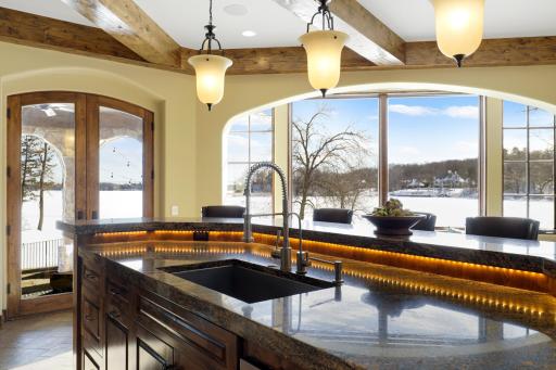 Experience expansive views of Smithtown Bay while cooking in your opulent chefâs kitchen, featuring Wolf and Sub-Zero appliances, natural stone countertops, and a walk-in pantry.