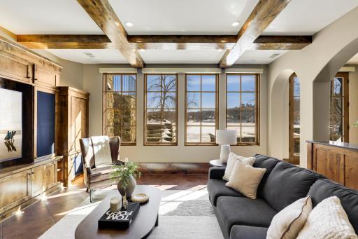 The walkout lower level is set for entertaining lake guests, boasting a fully equipped bar attached to the media room, a climate-controlled wine room, a tasting room, a 5th bedroom, additional storage, and a lake storage room with a 2nd laundry.