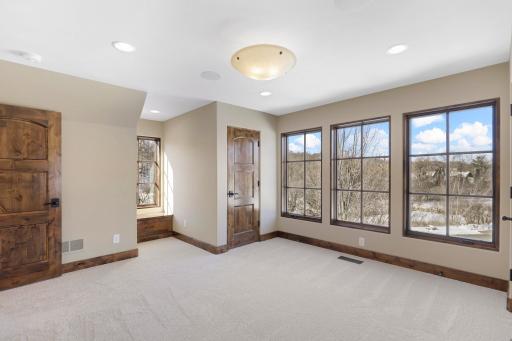 The upper-level hosts three additional bedrooms supported by two additional bathrooms, a well-appointed laundry room and a reading nook overlooking the great room.
